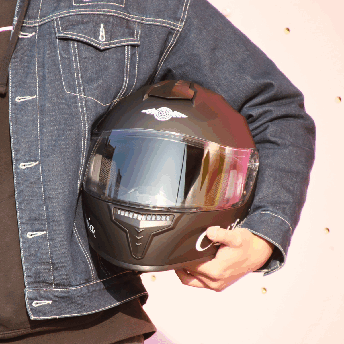 Freego California helmet held by rider, front view