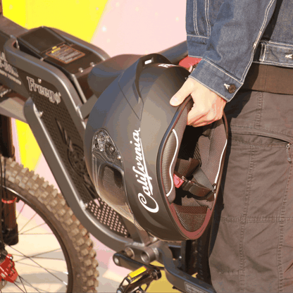 Freego California helmet held near Freego electric bike