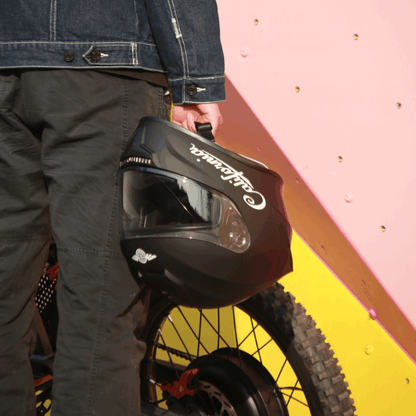 Freego California helmet held by rider, side view